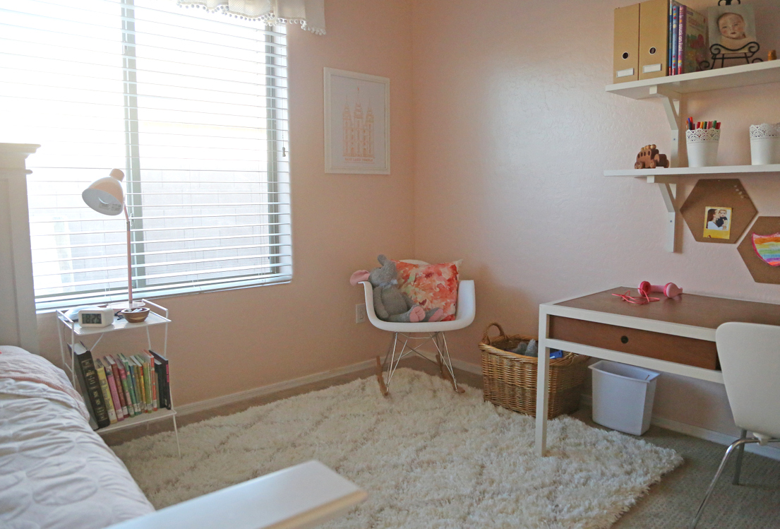 A light pink little girl's room with gold, wood, and coral accents A light pink little girl's room with gold, wood, and coral accents