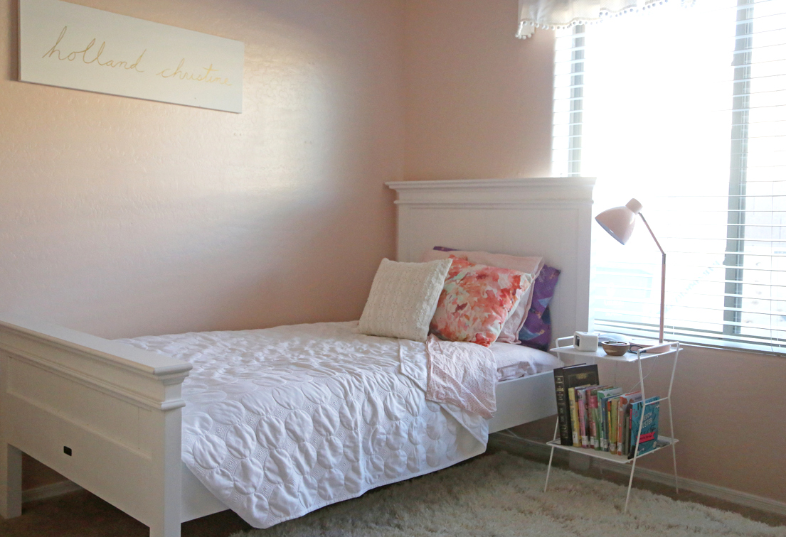 A light pink little girl's room with gold, wood, and coral accents A light pink little girl's room with gold, wood, and coral accents
