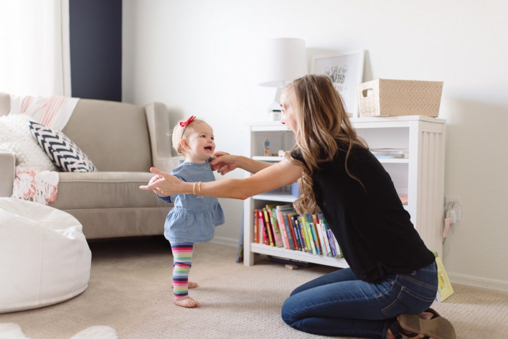 baby walking along furniture