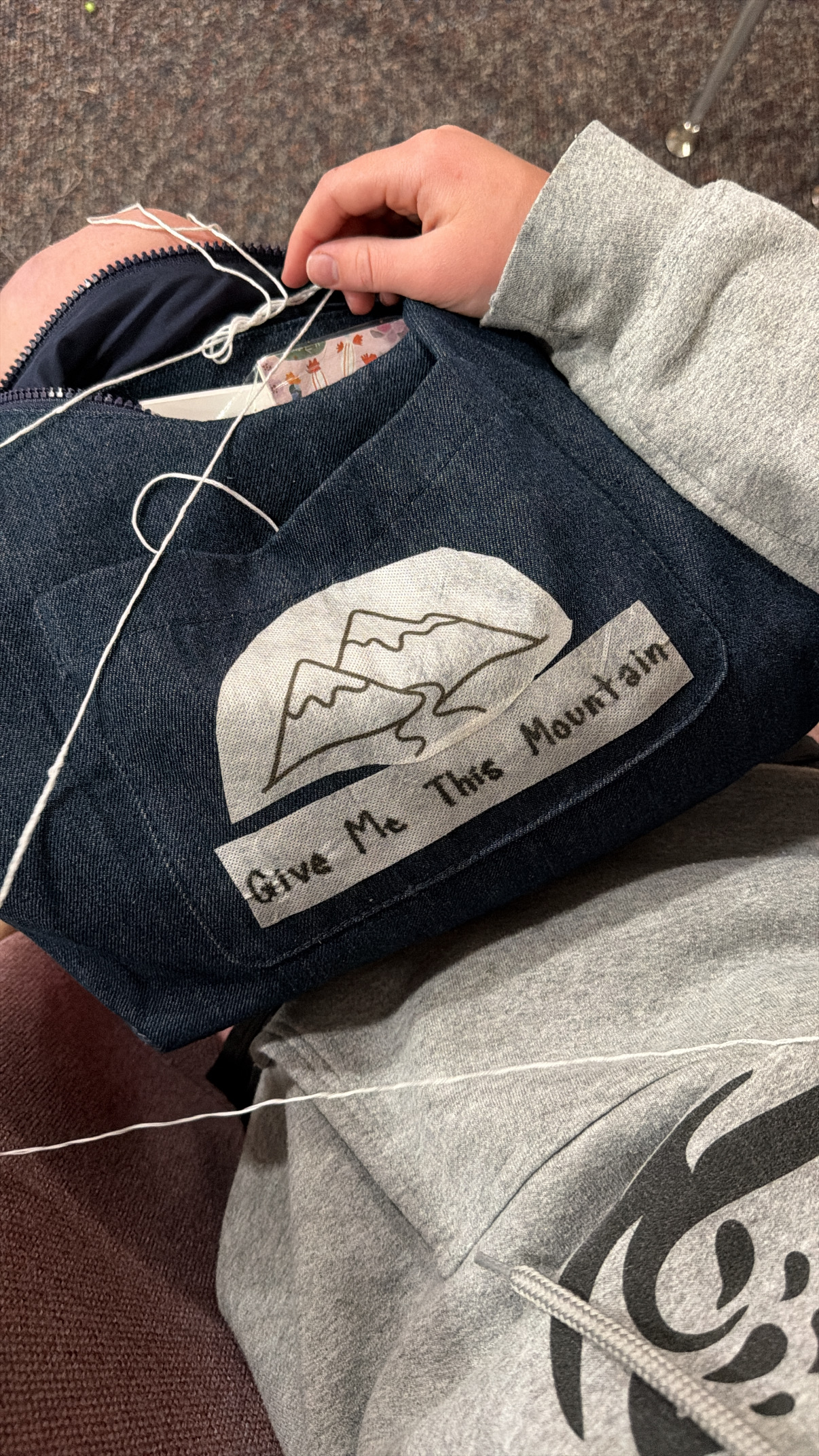 embroidering on a canvas bag