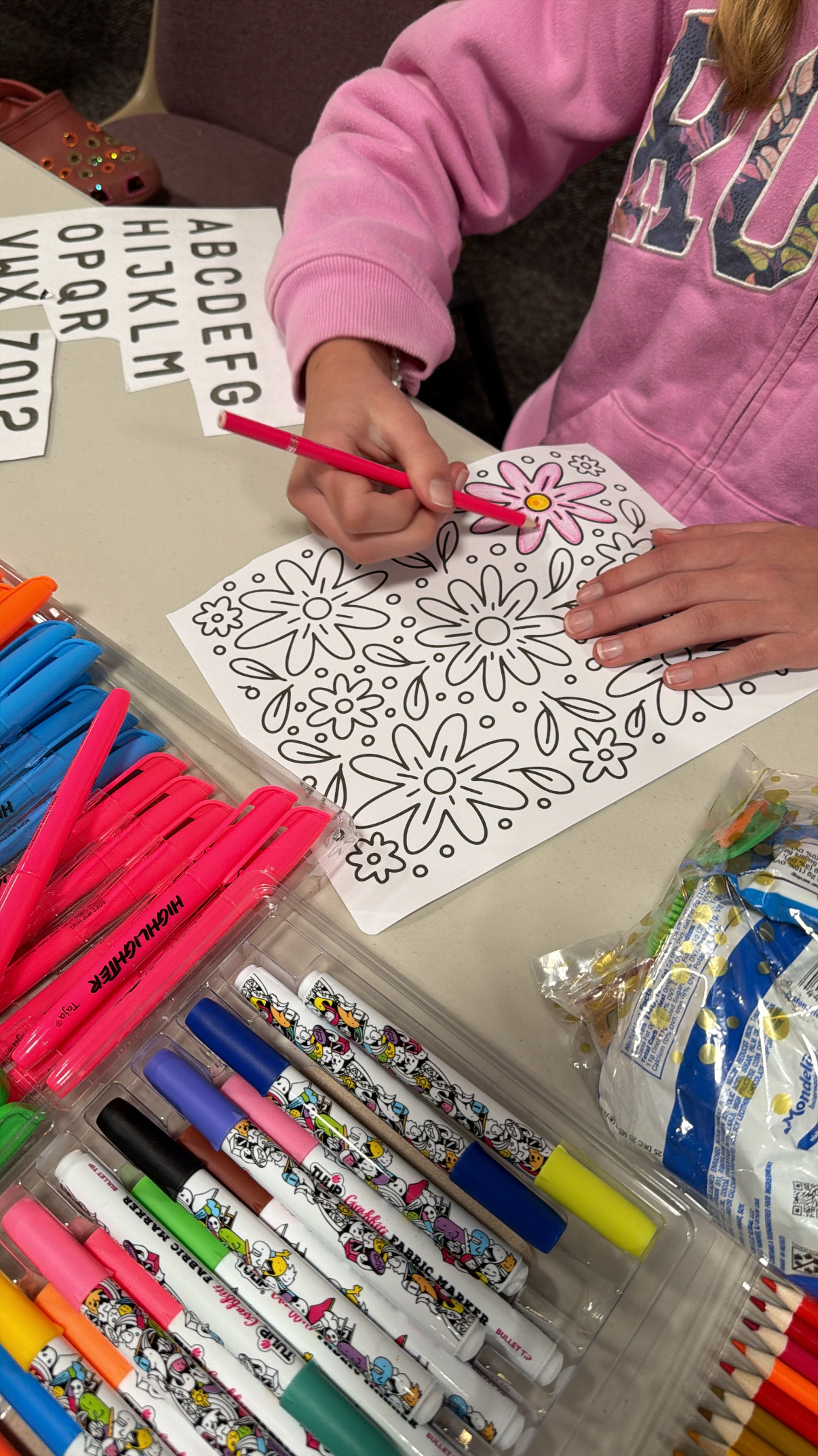 girl coloring a flower coloring page