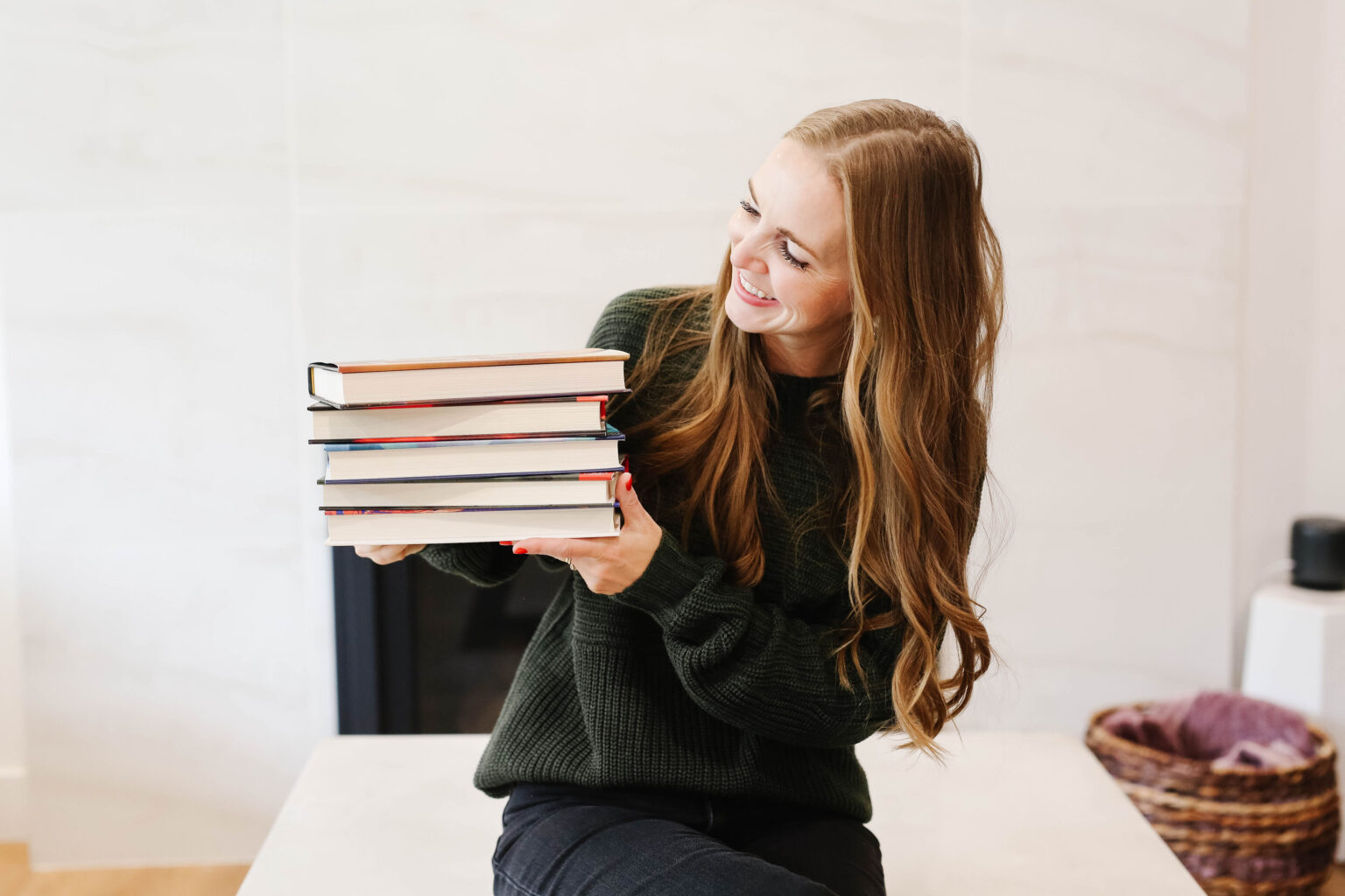 woman holding a stack of books